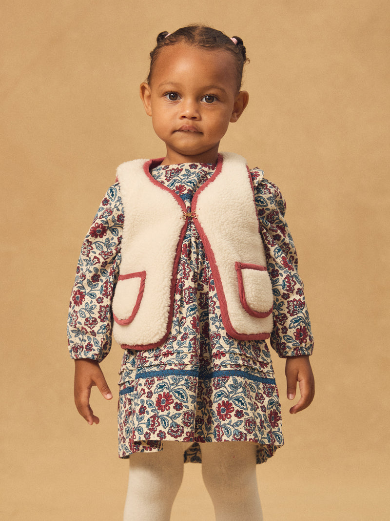 Cardigan sem mangas reversível em vermelho ou ecru para menina