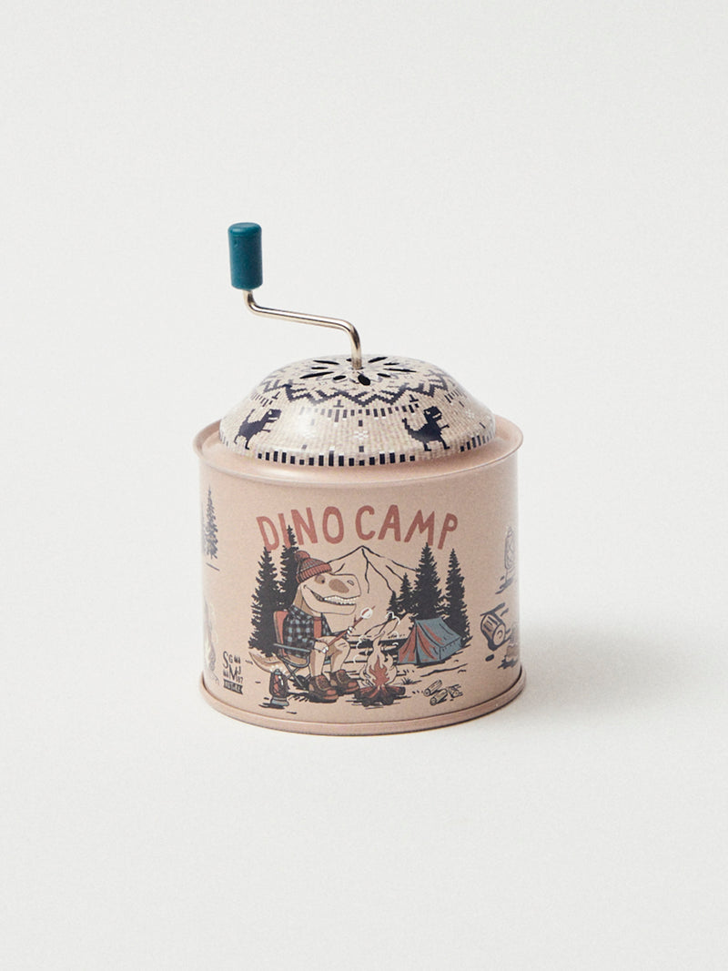 Caixa de música bege com impressão de dinossauros