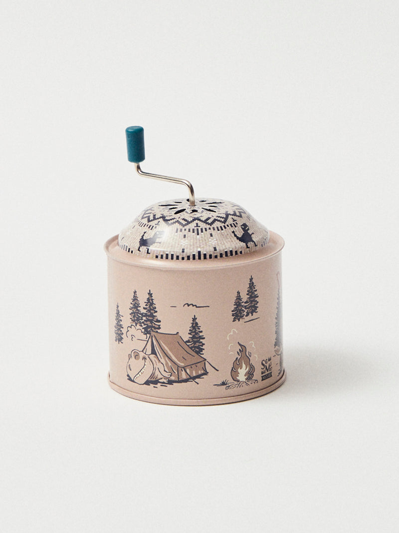 Caixa de música bege com impressão de dinossauros